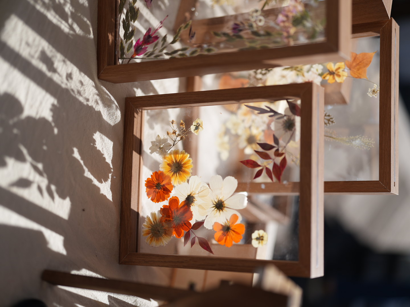 Flower compositions in warm, wooden frames